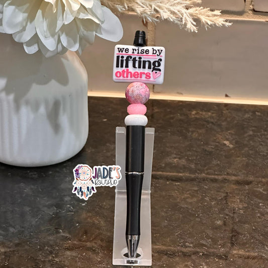 We Rise By Lifting Others Pink Pen